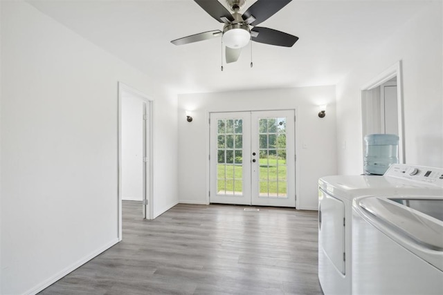 laundry area featuring french doors, separate washer and dryer, ceiling fan, and hardwood / wood-style floors