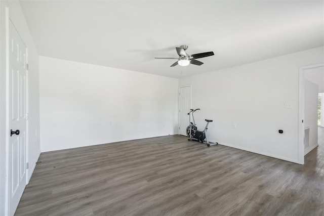 spare room featuring ceiling fan and dark hardwood / wood-style flooring