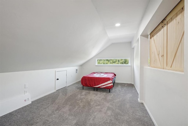 bedroom with carpet flooring and vaulted ceiling