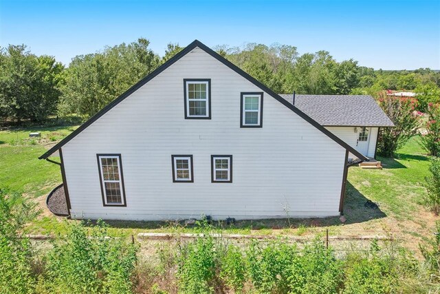 view of home's exterior with a lawn