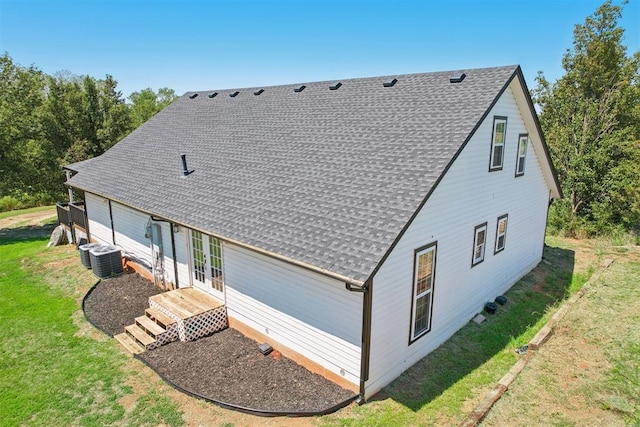 rear view of house with a yard, central AC, and french doors