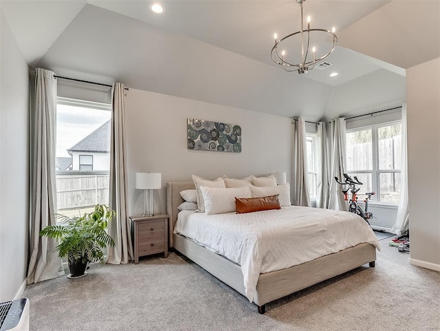 carpeted bedroom with a chandelier, vaulted ceiling, and multiple windows