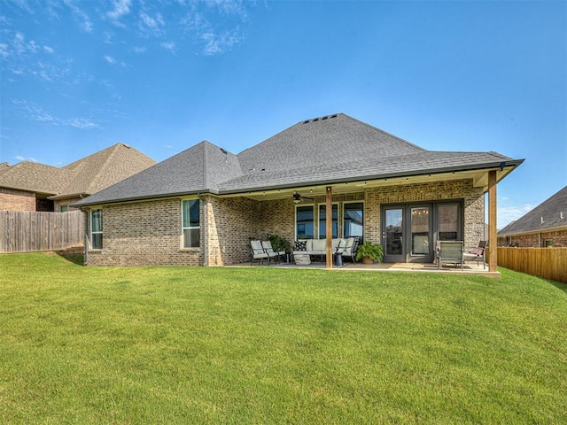 rear view of house featuring a lawn, ceiling fan, a patio, and an outdoor hangout area