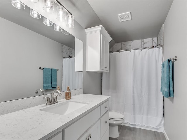 bathroom with a shower with curtain, hardwood / wood-style floors, vanity, and toilet