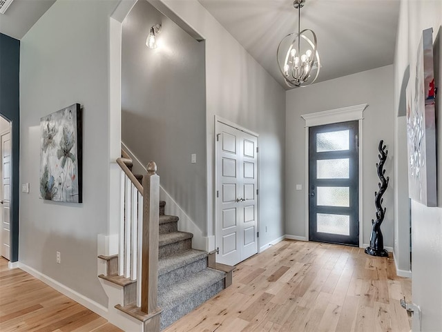 foyer with a chandelier and light hardwood / wood-style flooring