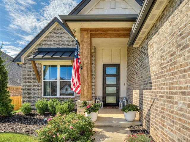 8216 Crew Ln, Edmond, OK 73034 - view of exterior entry with brick siding and a porch