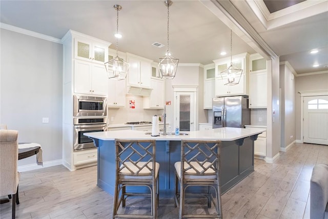 kitchen with white cabinetry, a kitchen island with sink, stainless steel appliances, and light hardwood / wood-style floors