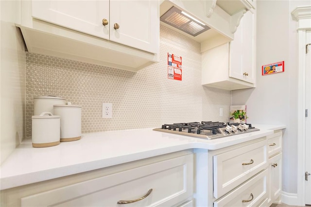 kitchen featuring custom range hood, white cabinetry, and stainless steel gas cooktop