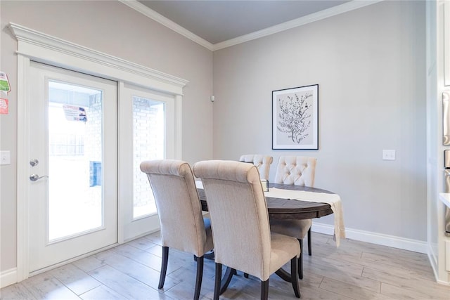 dining area with crown molding, french doors, and light hardwood / wood-style floors