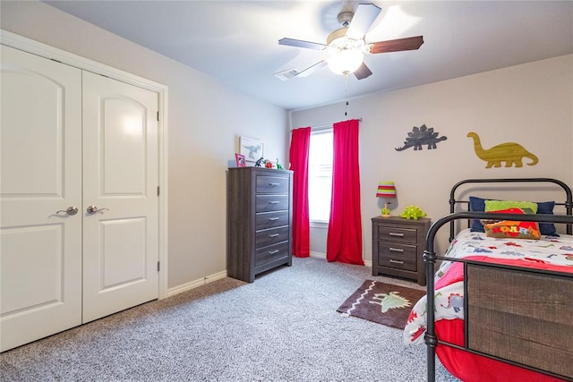 bedroom with ceiling fan, a closet, and light colored carpet