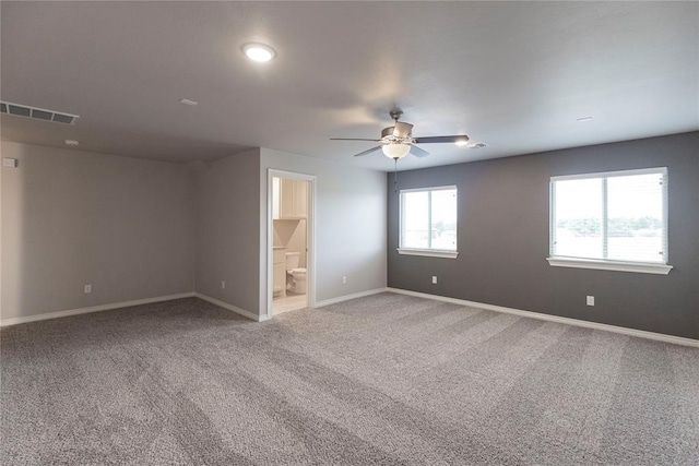 unfurnished room featuring carpet, ceiling fan, and a wealth of natural light