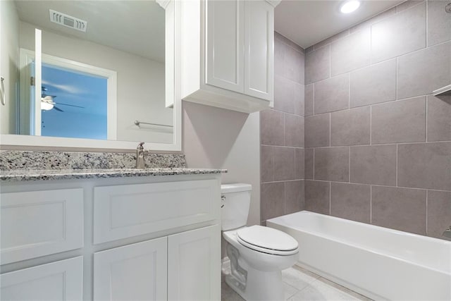 full bathroom featuring ceiling fan, tile patterned flooring, toilet, vanity, and tiled shower / bath