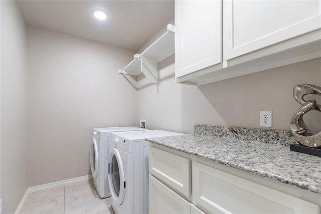 washroom featuring light tile patterned flooring, cabinets, and independent washer and dryer