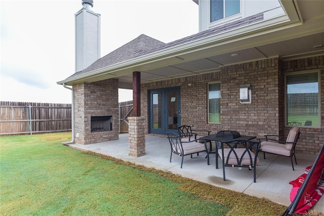 view of patio with french doors and an outdoor brick fireplace