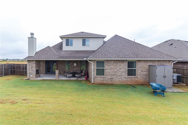 back of property with a yard, cooling unit, a patio, and a shed