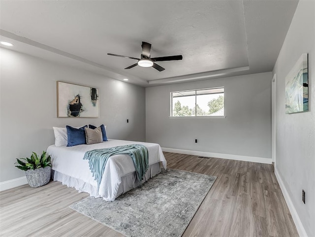 bedroom featuring light hardwood / wood-style flooring and ceiling fan