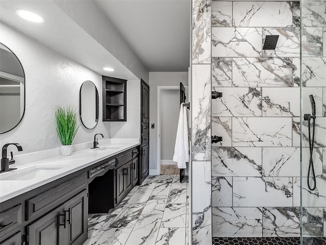 bathroom featuring a tile shower and vanity