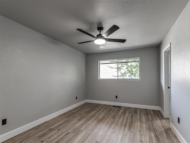 spare room featuring ceiling fan and light wood-type flooring