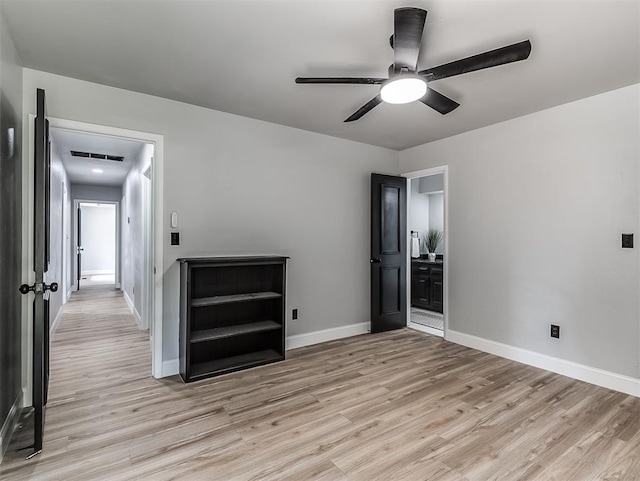 unfurnished bedroom featuring light wood-type flooring, ceiling fan, and connected bathroom