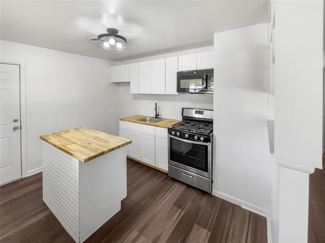 kitchen featuring wood counters, sink, dark hardwood / wood-style floors, white cabinetry, and stainless steel range with gas stovetop