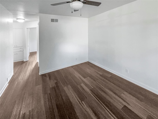 unfurnished room with ceiling fan and dark wood-type flooring