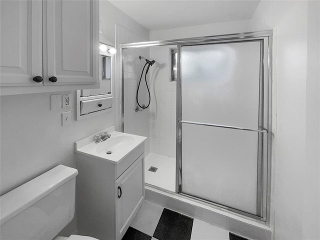 bathroom featuring toilet, vanity, and walk in shower