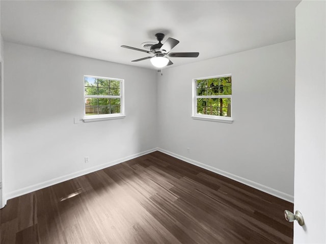 unfurnished room featuring dark hardwood / wood-style floors and ceiling fan