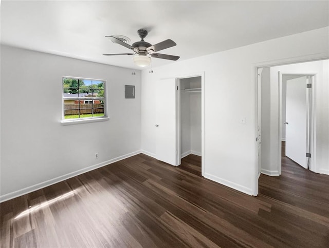 unfurnished bedroom with dark hardwood / wood-style flooring, a closet, and ceiling fan