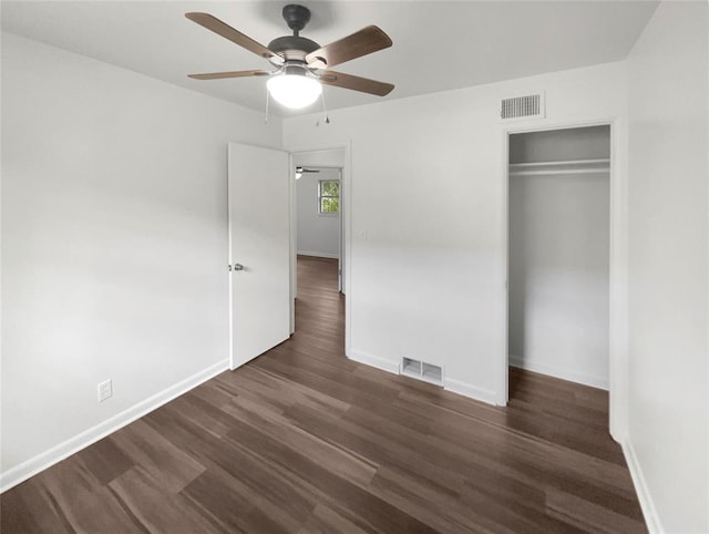 unfurnished bedroom with ceiling fan, a closet, and dark wood-type flooring