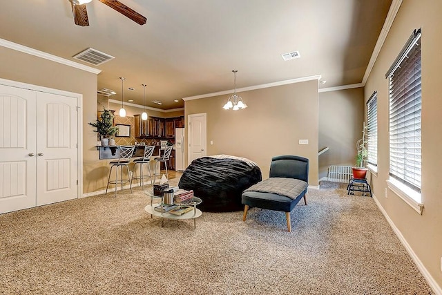 living room with light carpet, ceiling fan with notable chandelier, and crown molding