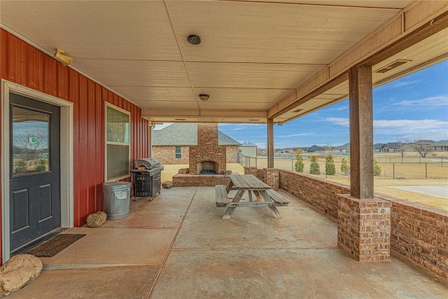 view of patio / terrace featuring a large fireplace and grilling area