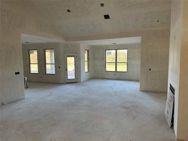 unfurnished room with vaulted ceiling