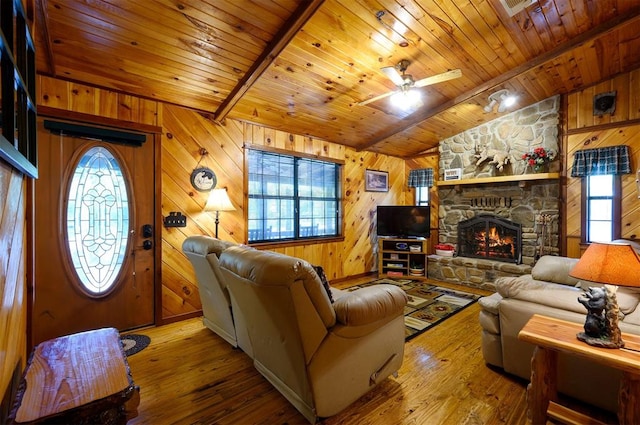 living room featuring hardwood / wood-style floors, a healthy amount of sunlight, and wood walls