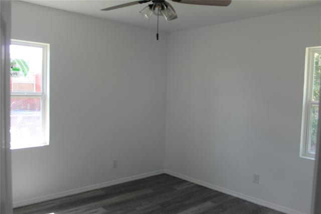 empty room featuring dark hardwood / wood-style flooring, ceiling fan, and a healthy amount of sunlight