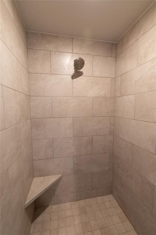 bathroom with a tile shower