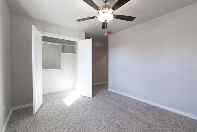 unfurnished bedroom with carpet floors, a closet, and ceiling fan