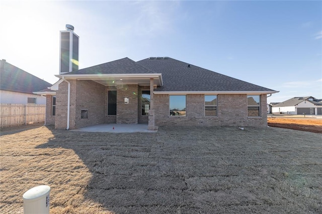 back of house with a patio and a yard