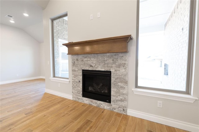 interior details featuring a stone fireplace and hardwood / wood-style floors