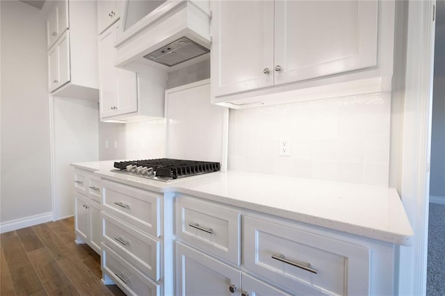 kitchen featuring white cabinetry, dark hardwood / wood-style flooring, custom range hood, and stainless steel gas stovetop