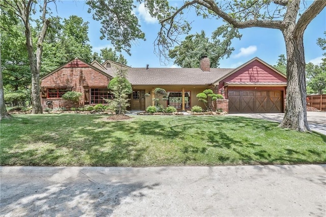 view of front of house with a garage and a front lawn