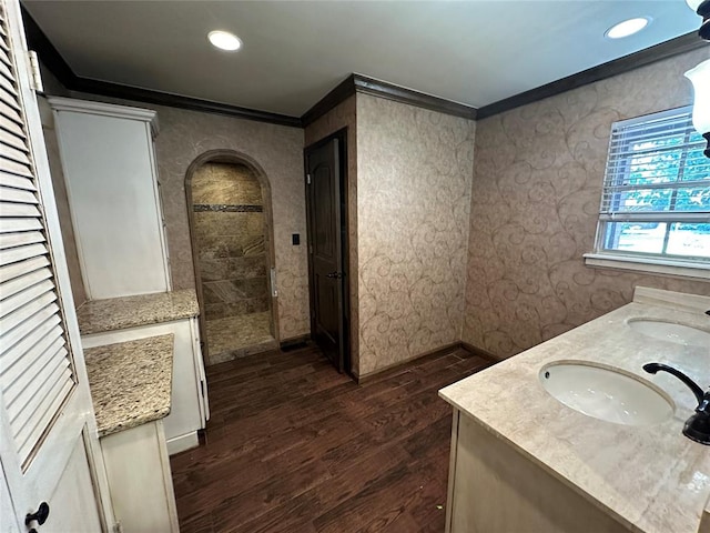 bathroom featuring hardwood / wood-style floors, vanity, and crown molding