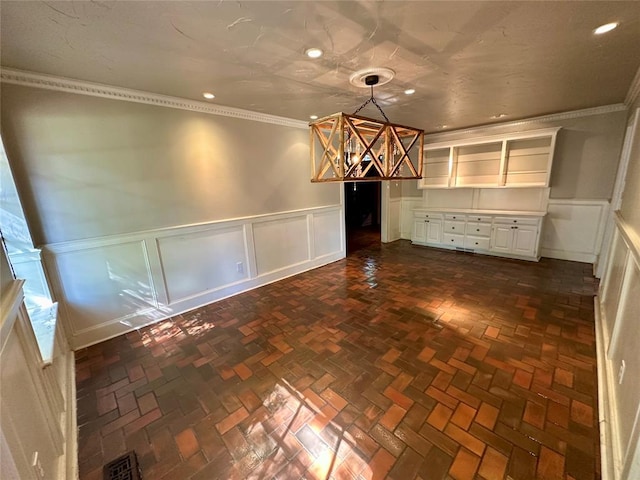 unfurnished dining area with crown molding