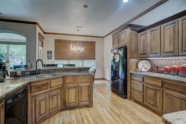 kitchen with black appliances, crown molding, sink, light hardwood / wood-style flooring, and a notable chandelier