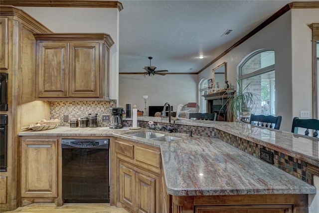 kitchen with black appliances, sink, ceiling fan, light stone counters, and kitchen peninsula