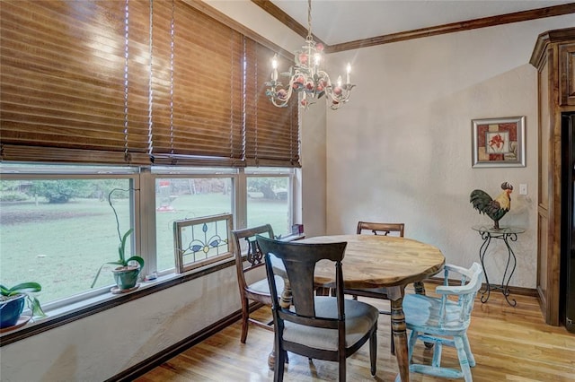 dining space with light wood-type flooring, crown molding, a wealth of natural light, and a notable chandelier