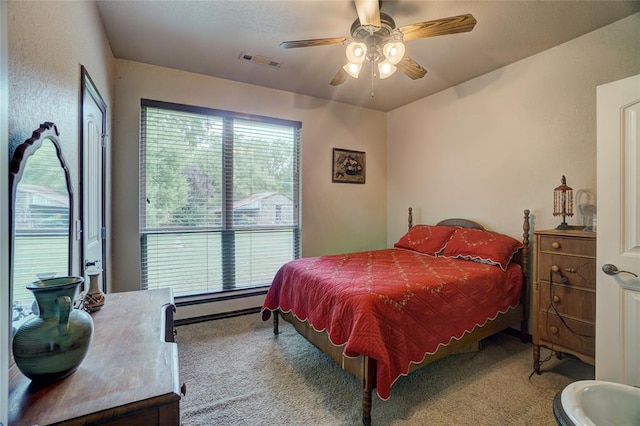 bedroom featuring ceiling fan, light colored carpet, and a baseboard radiator