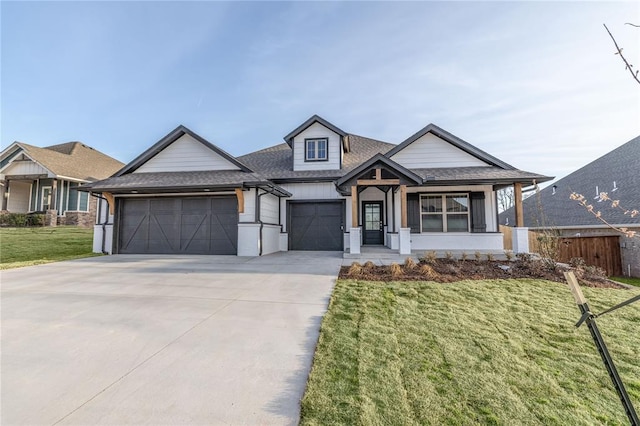 view of front of home with a garage, a front yard, fence, a shingled roof, and driveway