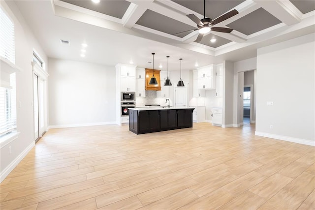 kitchen with open floor plan, a ceiling fan, visible vents, stainless steel appliances, and a sink