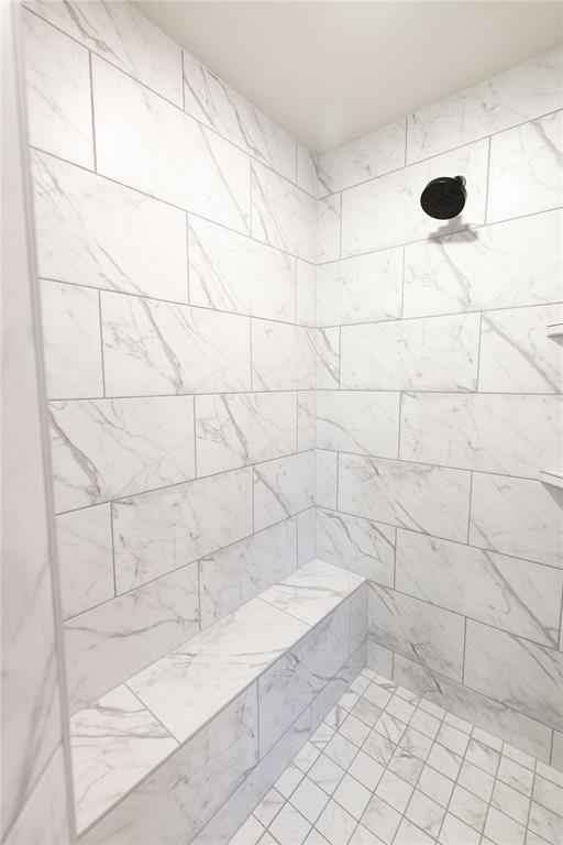 bathroom with a tile shower