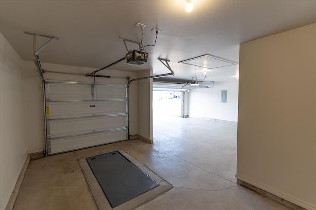 garage with electric panel, baseboards, and a garage door opener